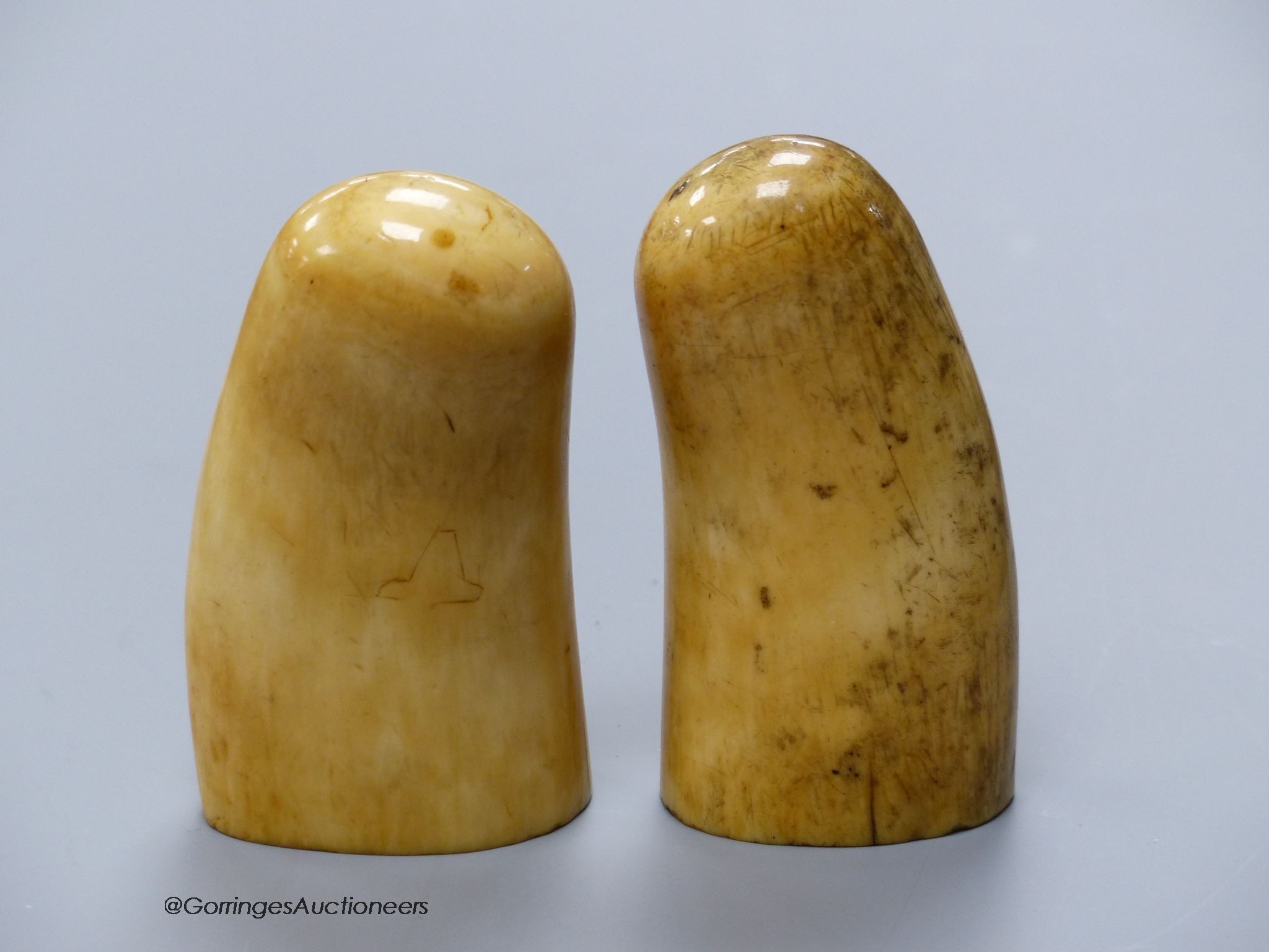 Two 19th century scrimshaw sperm whale teeth, engraved with Victorian figures, height 10cm